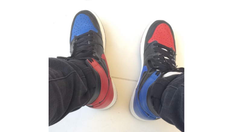 A photo of the Jordan 1 "Top 3" with a alternating blue and red color way on a black base.