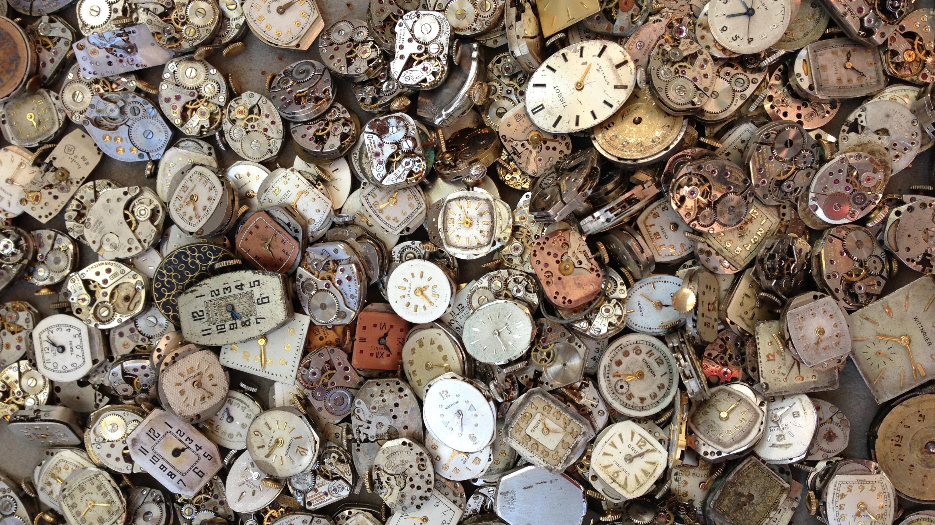 Aerial view of hundreds of clocks piled on top of each other