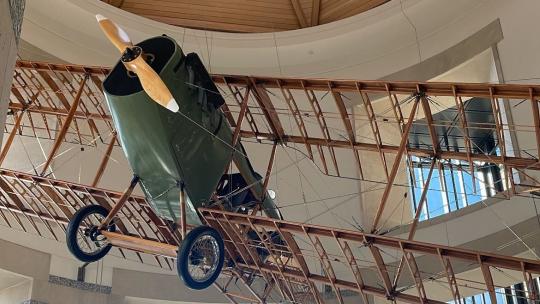 A photo of an old-school model plane hanging at the Minnesota History Center.